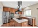 Spacious kitchen featuring stainless steel appliances, a modern island cooktop, and ample counter space at 12635 Tuscany Blvd, Carmel, IN 46032