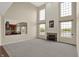 Open-concept living room with fireplace and expansive windows, blending comfort with elegant design at 12635 Tuscany Blvd, Carmel, IN 46032
