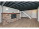 Finished basement with a brick fireplace, plank flooring, and stairs at 138 Plaza Chica St, Greenwood, IN 46143