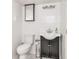 Classic bathroom with white subway tile, mosaic floors, black vanity, and modern fixtures creates a timeless look at 138 Plaza Chica St, Greenwood, IN 46143