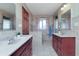 Bathroom with dual sink vanities, tiled floors, and a bright window at 138 Plaza Chica St, Greenwood, IN 46143