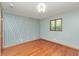 Bedroom with hardwood floors, patterned wallpaper, and natural light at 138 Plaza Chica St, Greenwood, IN 46143