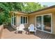Cozy deck with two white adirondack chairs overlooking a lush green landscape offers a tranquil outdoor experience at 138 Plaza Chica St, Greenwood, IN 46143