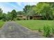 Beautifully landscaped front yard with mature trees surrounding a well-maintained home at 138 Plaza Chica St, Greenwood, IN 46143