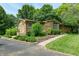 Charming stone home with landscaped yard, mature trees, and inviting front entrance at 138 Plaza Chica St, Greenwood, IN 46143