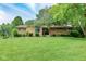 Charming single-story home with stone facade and a well-maintained lawn and mature trees at 138 Plaza Chica St, Greenwood, IN 46143