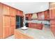 Kitchen with wood cabinets, granite countertops, stainless steel appliances, and a center island at 138 Plaza Chica St, Greenwood, IN 46143