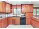 Kitchen features wood cabinets, granite countertops, stainless steel appliances, and a breakfast bar at 138 Plaza Chica St, Greenwood, IN 46143