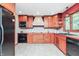 Kitchen features wood cabinets, stainless steel appliances, tile backsplash, and a breakfast bar at 138 Plaza Chica St, Greenwood, IN 46143
