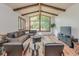 Bright living room features vaulted ceilings, wood beams, hardwood floors, and a large window with a beautiful view at 138 Plaza Chica St, Greenwood, IN 46143