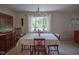 Charming dining area with bay window offering natural light, vintage chandelier and seating for four at 1524 Northcrest Dr, Anderson, IN 46012