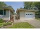 A well-maintained exterior showcasing a detached garage with garden decor and lawn at 1524 Northcrest Dr, Anderson, IN 46012