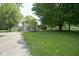 Two-story home featuring a well-maintained lawn and mature trees, set back from a concrete driveway at 1524 Northcrest Dr, Anderson, IN 46012