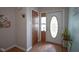 Entryway with hardwood floors, decorative front door, and neutral wall paint at 1524 Northcrest Dr, Anderson, IN 46012