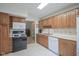 Bright kitchen with lots of cabinet space, black appliances and a window above the sink at 1524 Northcrest Dr, Anderson, IN 46012
