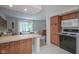 Kitchen with a breakfast bar that opens into the dining room at 1524 Northcrest Dr, Anderson, IN 46012