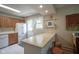Bright kitchen featuring a functional breakfast bar area with wooden stools, for easy meal prep and dining at 1524 Northcrest Dr, Anderson, IN 46012