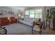 Inviting living room with comfortable seating, soft lighting, and neutral carpet at 1524 Northcrest Dr, Anderson, IN 46012