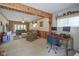 Open-concept living area with wood trim, two seating areas, natural light, and an adjacent office space at 1524 Northcrest Dr, Anderson, IN 46012