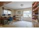 Bright office space featuring a desk, piano, carpeted floors, and window views of the backyard at 1524 Northcrest Dr, Anderson, IN 46012