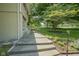 Stone steps leading to the backyard, surrounded by garden beds, and a decorative solar lamp at 1524 Northcrest Dr, Anderson, IN 46012