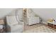 Cozy bedroom featuring white chair, dresser, and carpet with plenty of natural light at 1623 Hoyt Ave, Indianapolis, IN 46203