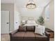 Comfortable bedroom with a full-sized bed, decorative lighting, and a sleeper sofa at 1623 Hoyt Ave, Indianapolis, IN 46203