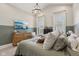 Comfortable bedroom featuring a stylish chandelier, neutral color palette, and lots of natural light at 1623 Hoyt Ave, Indianapolis, IN 46203