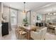 Dining area featuring a wooden table set for four and ample natural light at 1623 Hoyt Ave, Indianapolis, IN 46203
