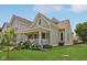 Quaint two-story home with a charming front porch, green lawn, and beautiful curb appeal at 1623 Hoyt Ave, Indianapolis, IN 46203