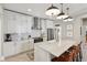 Bright kitchen with white cabinets, stainless steel appliances, marble countertops, and mosaic tile backsplash at 1623 Hoyt Ave, Indianapolis, IN 46203