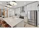 Bright kitchen featuring stainless steel appliances, white cabinets, large island and view of living area at 1623 Hoyt Ave, Indianapolis, IN 46203