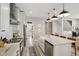 Modern kitchen with stainless steel appliances, marble countertops, white cabinetry, and large kitchen island at 1623 Hoyt Ave, Indianapolis, IN 46203