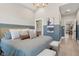 A relaxing main bedroom with comfortable linens, stylish décor and a view of the attached bathroom and living room at 1623 Hoyt Ave, Indianapolis, IN 46203