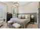 A relaxing main bedroom with natural light, a woven headboard, comfortable linens and a chandelier at 1623 Hoyt Ave, Indianapolis, IN 46203
