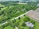 Expansive aerial view of farmland and wooded area with houses and paved roads at 17320 Joliet Rd, Westfield, IN 46074