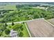 Beautiful aerial view showcases property with farmland, wooded area, and large yard at 17320 Joliet Rd, Westfield, IN 46074