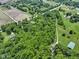 Expansive aerial view of lush, wooded property with farmhouse and adjacent fields at 17320 Joliet Rd, Westfield, IN 46074