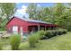 Exterior of red barn with covered porch, set amidst lush greenery at 17320 Joliet Rd, Westfield, IN 46074