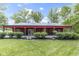 Charming red barn with a covered porch, set amidst a well-manicured lawn at 17320 Joliet Rd, Westfield, IN 46074