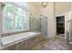 Bright bathroom featuring a large soaking tub and glass enclosed shower at 17320 Joliet Rd, Westfield, IN 46074
