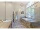 Bathroom featuring a large soaking tub, glass enclosed shower and vanity at 17320 Joliet Rd, Westfield, IN 46074