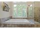 Close up of a soaking tub with windows and a glass enclosed shower at 17320 Joliet Rd, Westfield, IN 46074