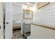 Modern bathroom with stylish vanity, a wood-framed mirror, light fixtures, and nice wall decor at 17320 Joliet Rd, Westfield, IN 46074