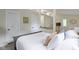 Well-lit bedroom featuring white linens, stylish pillows, and views into adjacent living spaces at 17320 Joliet Rd, Westfield, IN 46074
