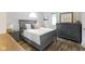 Comfortable bedroom with a gray bed frame, hardwood floors and ample natural light from nearby windows at 17320 Joliet Rd, Westfield, IN 46074