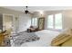 Bright bedroom with two windows, ceiling fan, light walls, closet and wooden floor at 17320 Joliet Rd, Westfield, IN 46074