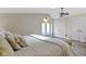Comfortable bedroom with a bed, closets, ceiling fan, light walls and light-colored wooden floor at 17320 Joliet Rd, Westfield, IN 46074