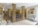 Open-concept dining room with brick columns, fireplace, wood floors and neutral palette for modern living at 17320 Joliet Rd, Westfield, IN 46074