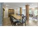 Formal dining room with long table, brick columns, and view into living room at 17320 Joliet Rd, Westfield, IN 46074